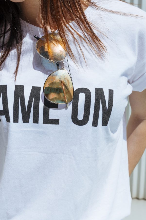 Crop woman in T-shirt with writing